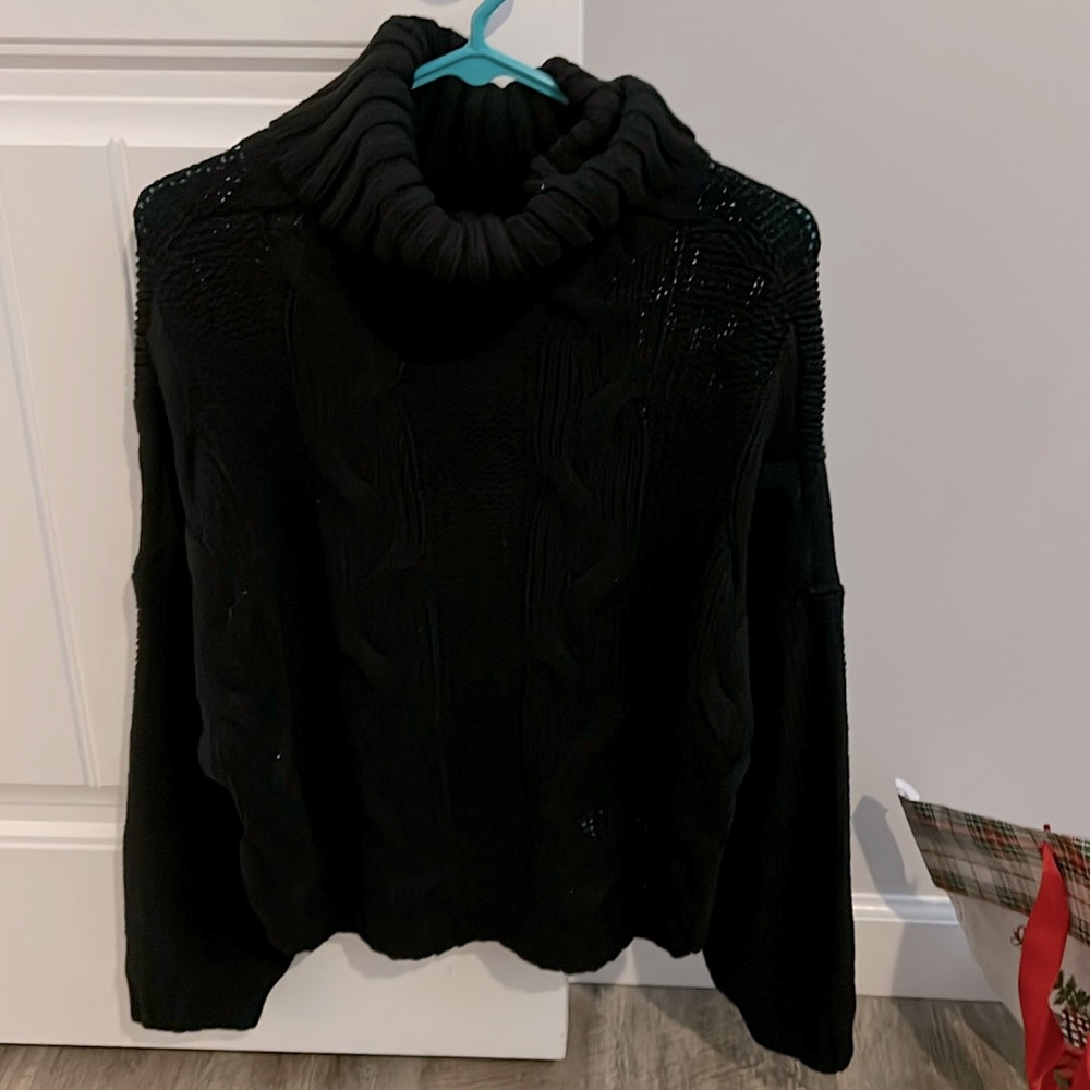 Woman’s black turtleneck sweater